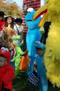 kids in cookie monster costume with big bird