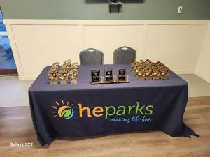 heparks branded tablecloth with trophy awards on a table