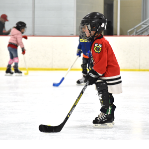 kid in hockey gear on the ice at TC ice arena
