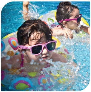 girls in pool with floaties and sunglasses