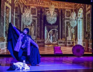 an image of a dramatic play in purple lighting