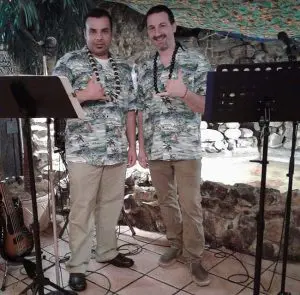 Two musicians in Hawaiian Shirts on a stage