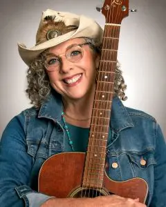 Jeanie B in cowboy hat with guitar portrait