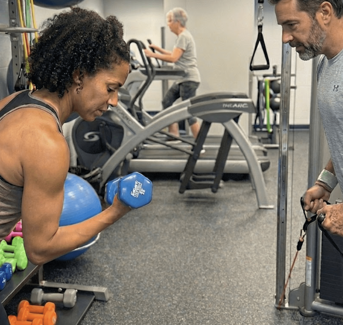 a person and person working out in a gym
