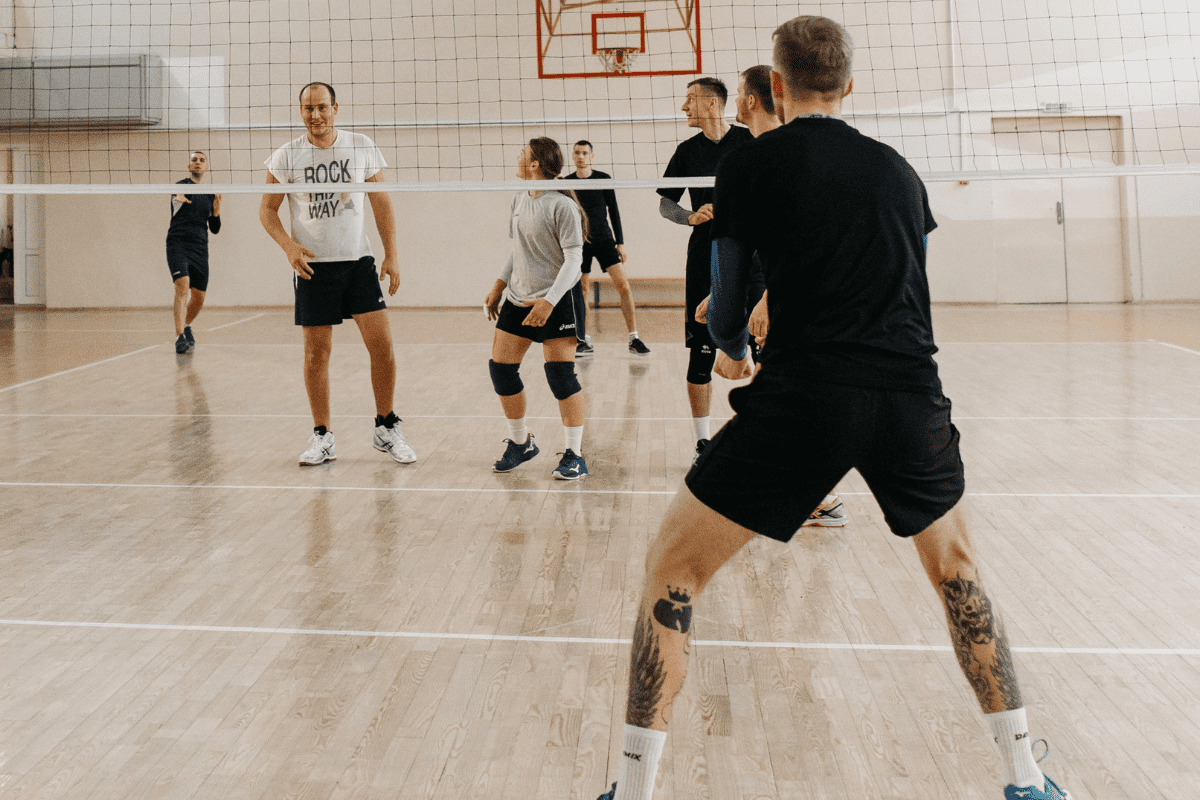 Adults playing indoor Volleyball