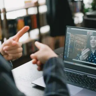 Hands signing ESL at a computer training course
