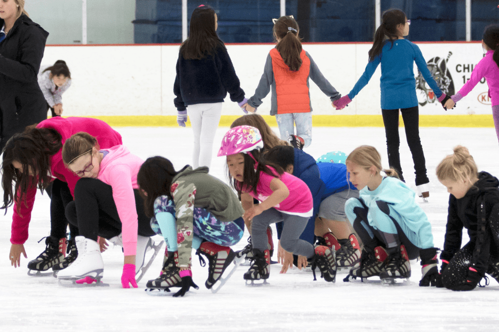 kids in a line holding hands on the ice
