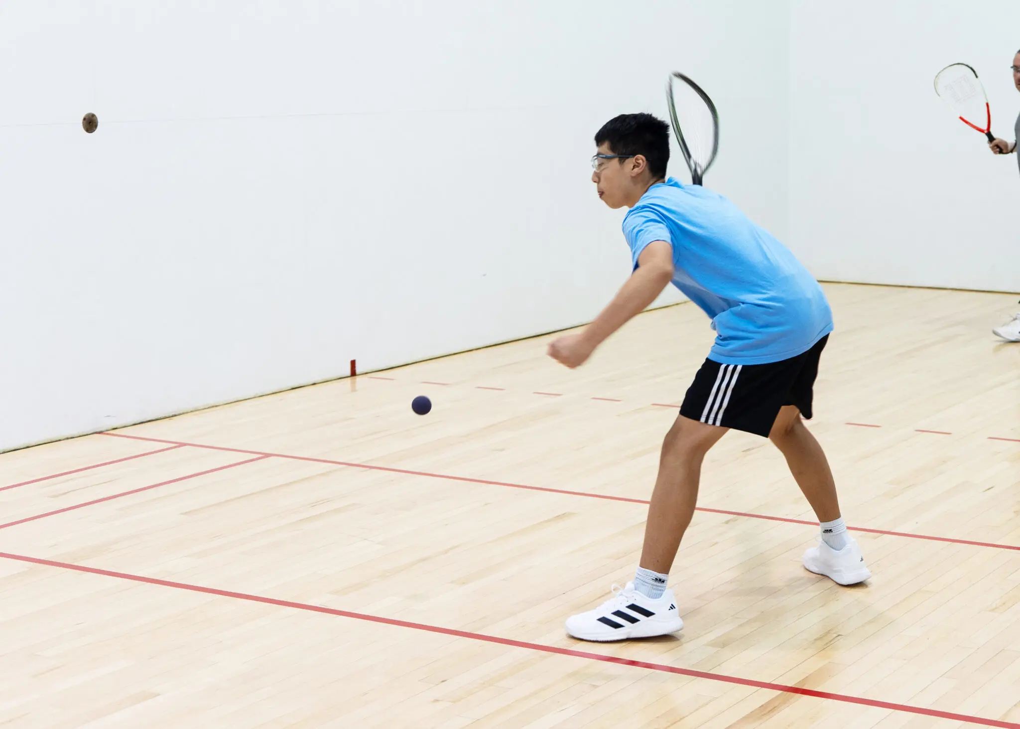 youth boy playing racquetball