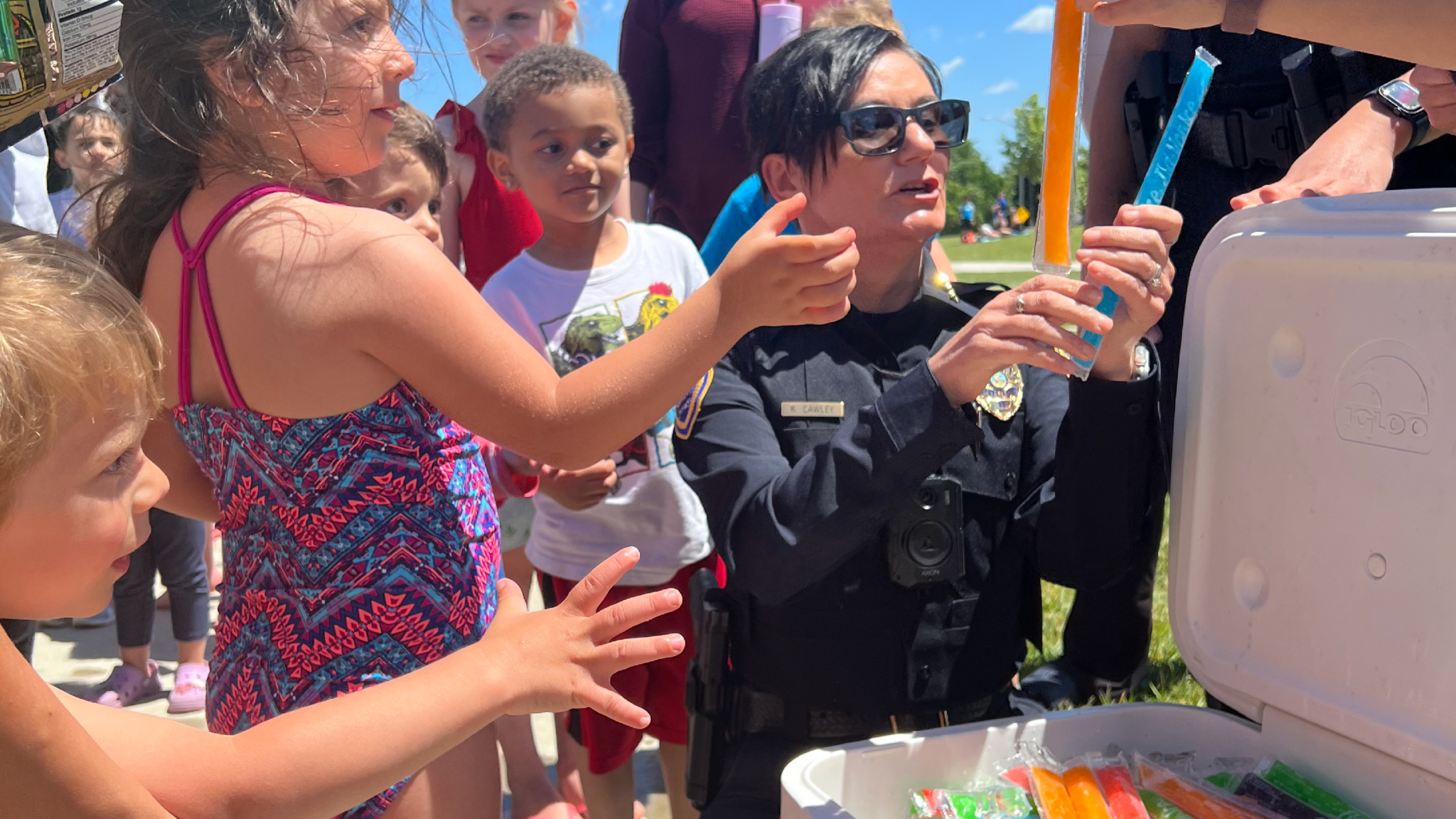 a police officer giving a child a treat