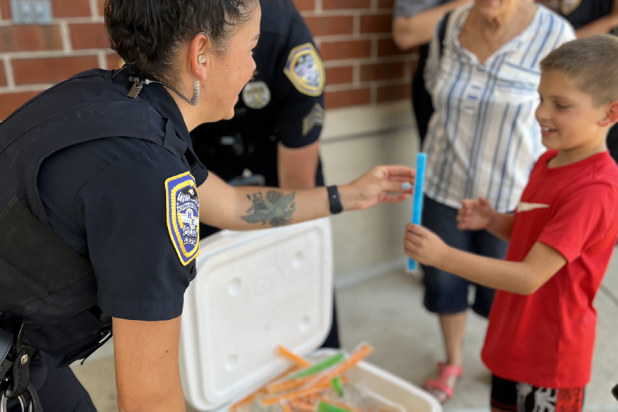 a police officer holding a blue tube