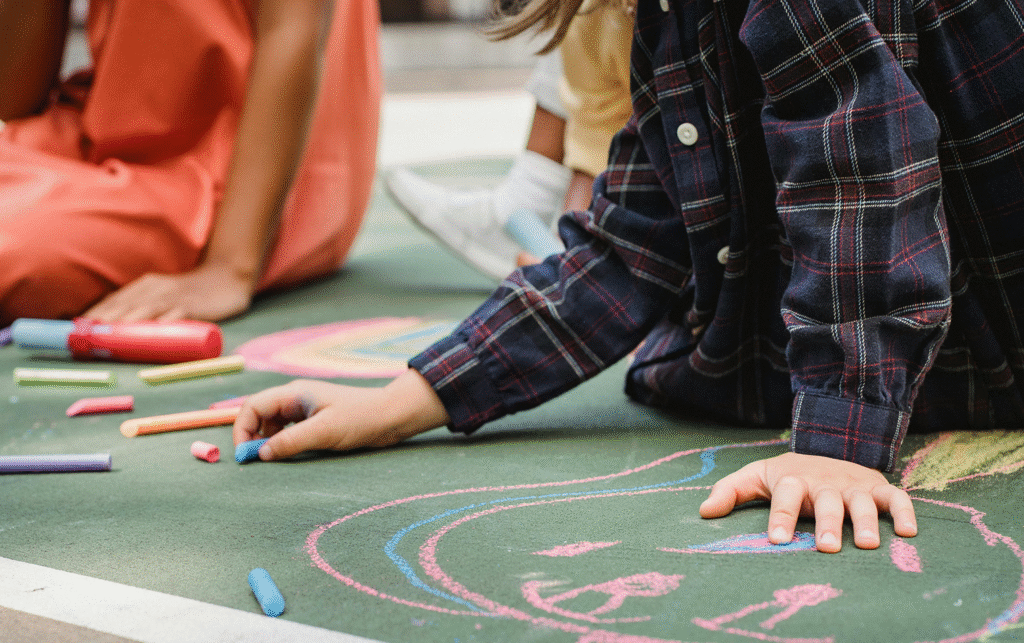 a child drawing on a chalkboard