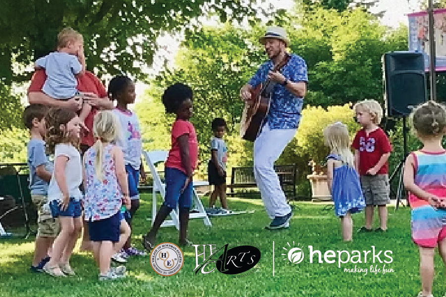 a person playing guitar with kids around him