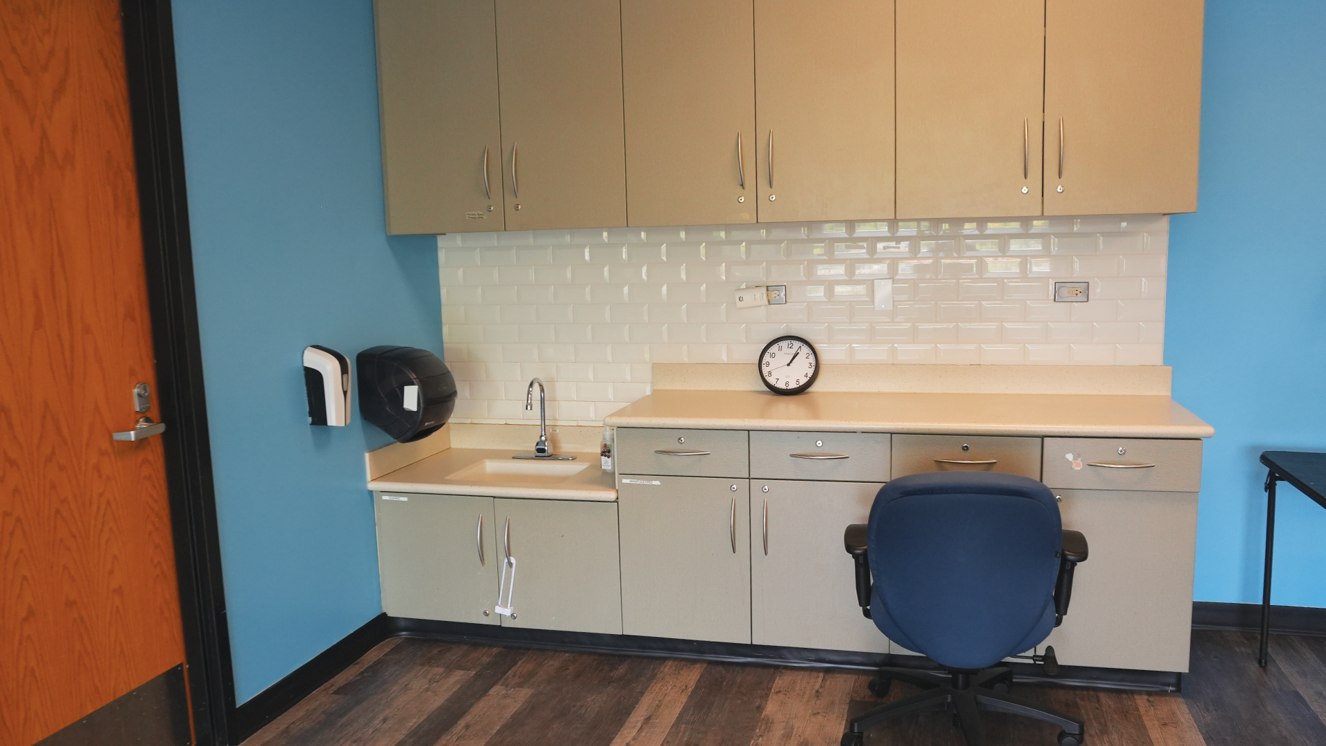 a room with a sink and a chair