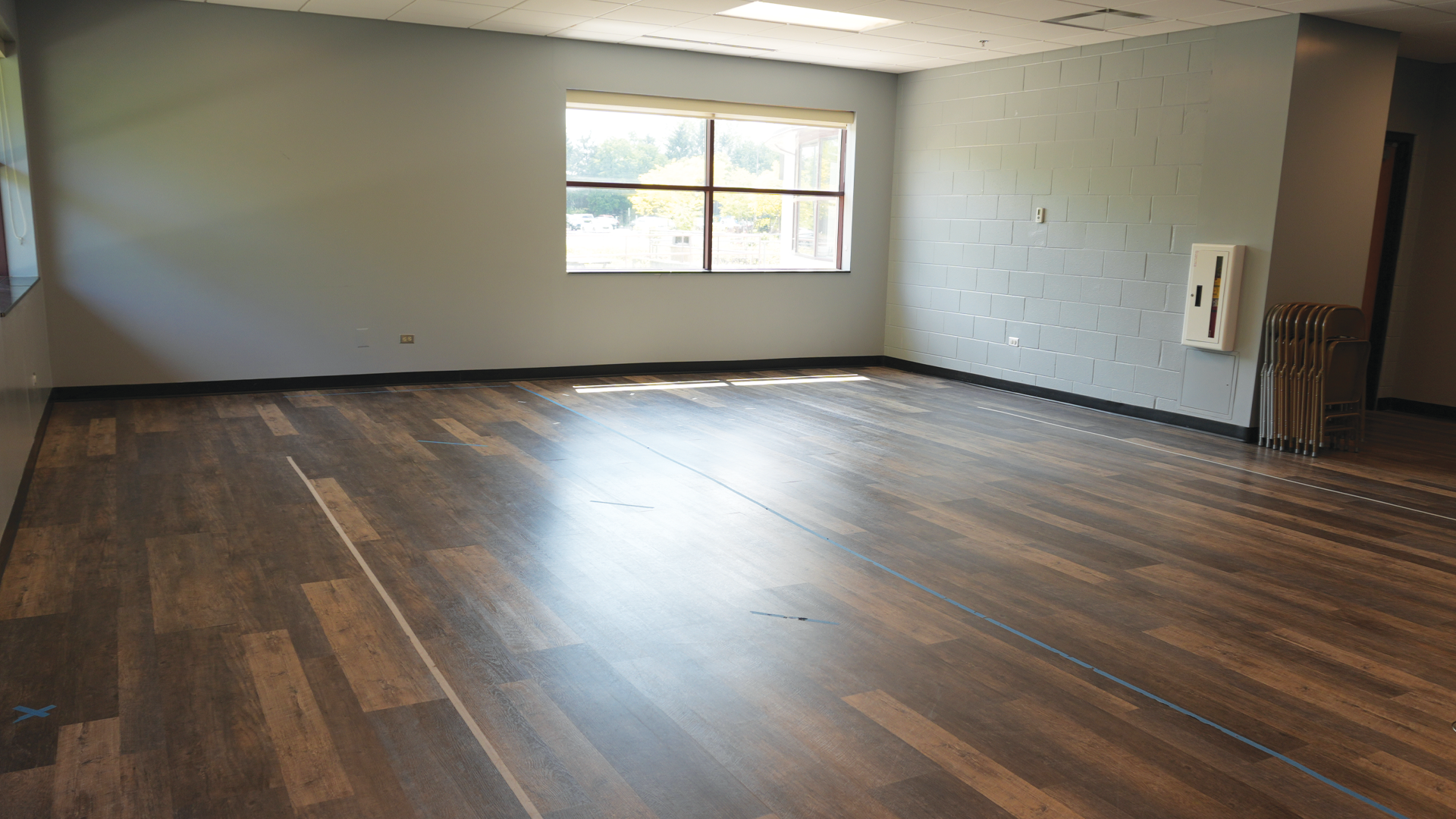 a room with a wood floor and a window