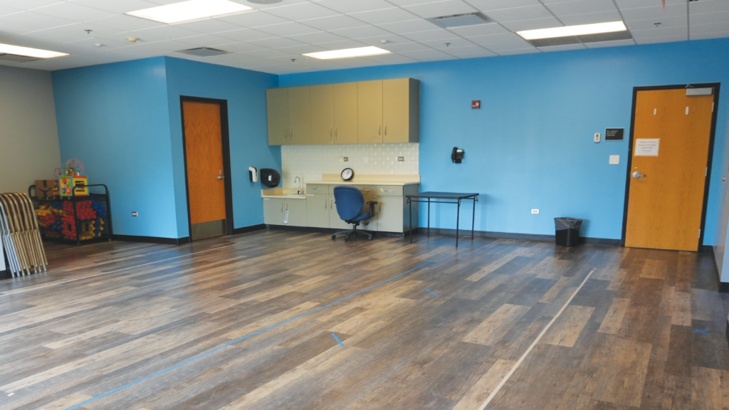 a room with a blue wall and a wood floor