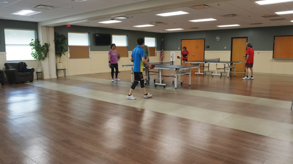 a group of people playing ping pong