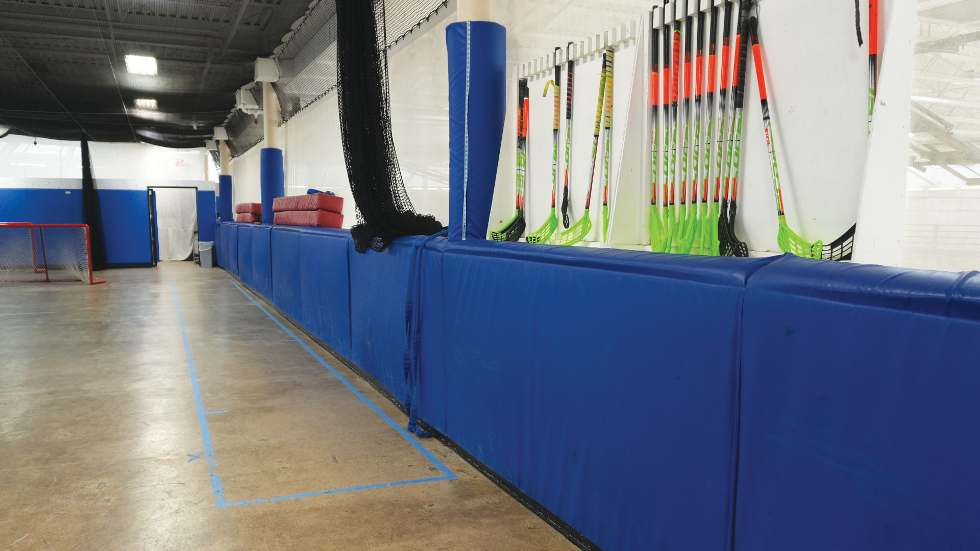 a wall with hockey sticks and equipment