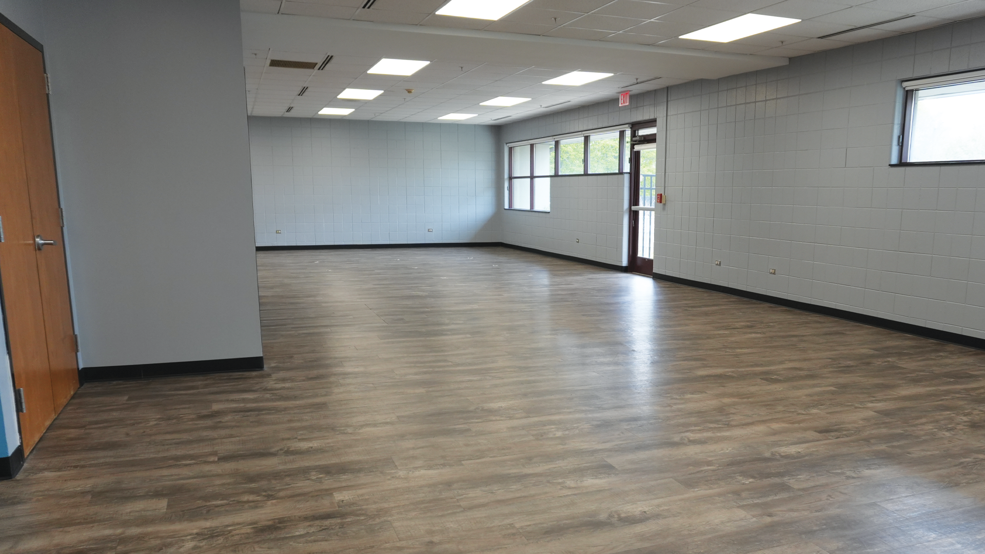 a room with wood floor and white walls