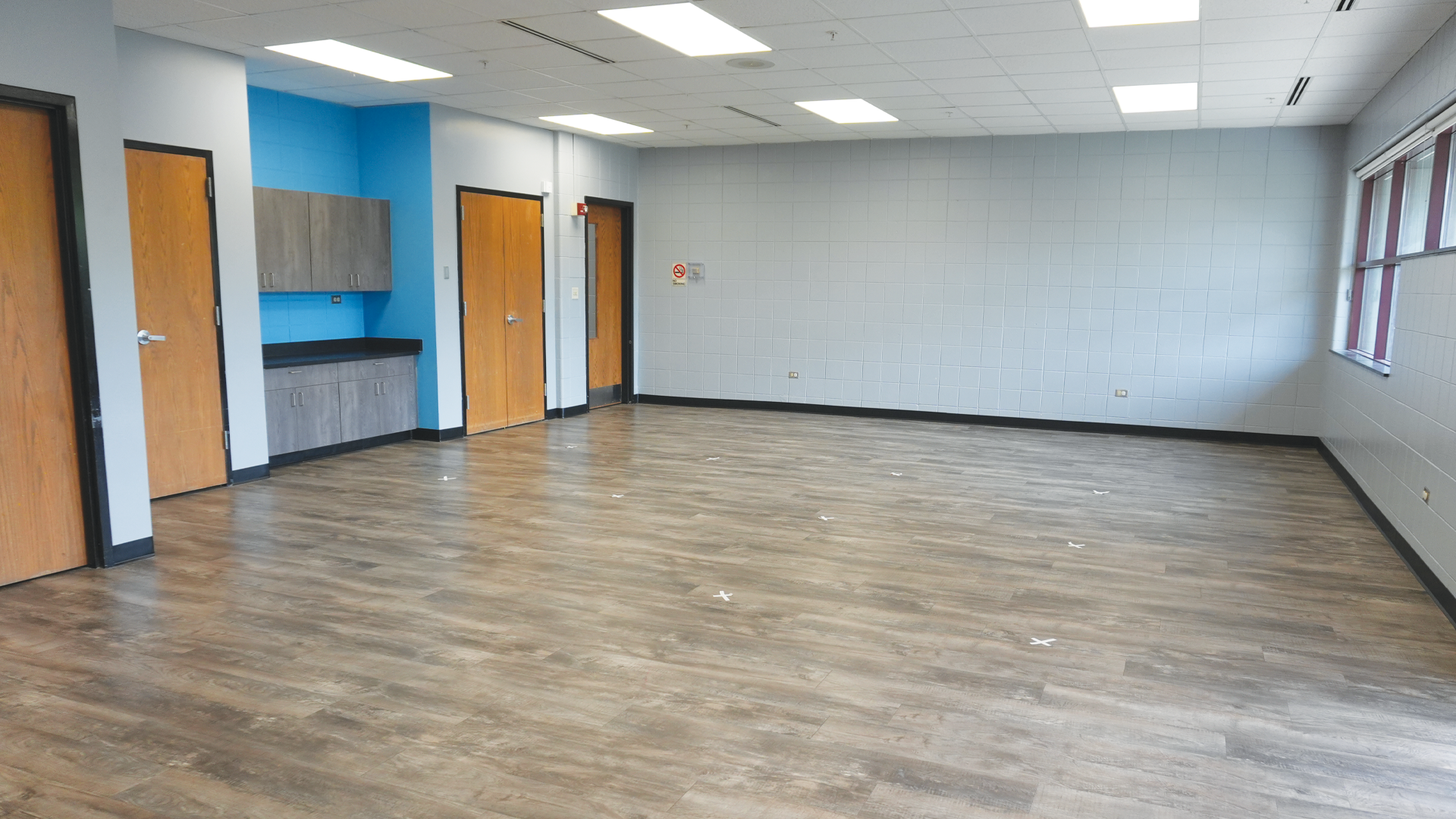 a room with wood floor and a blue wall
