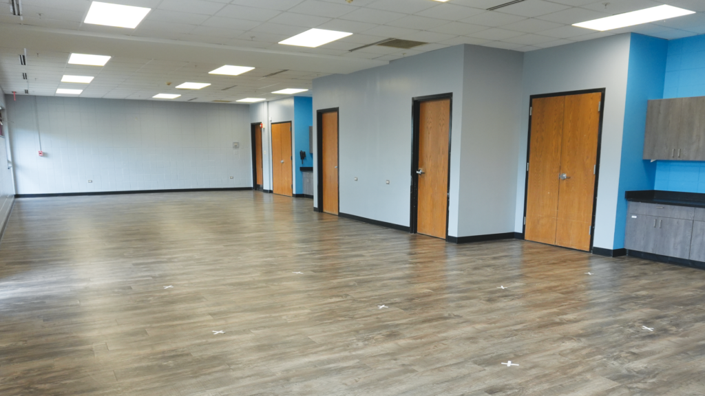 a room with doors and a wood floor