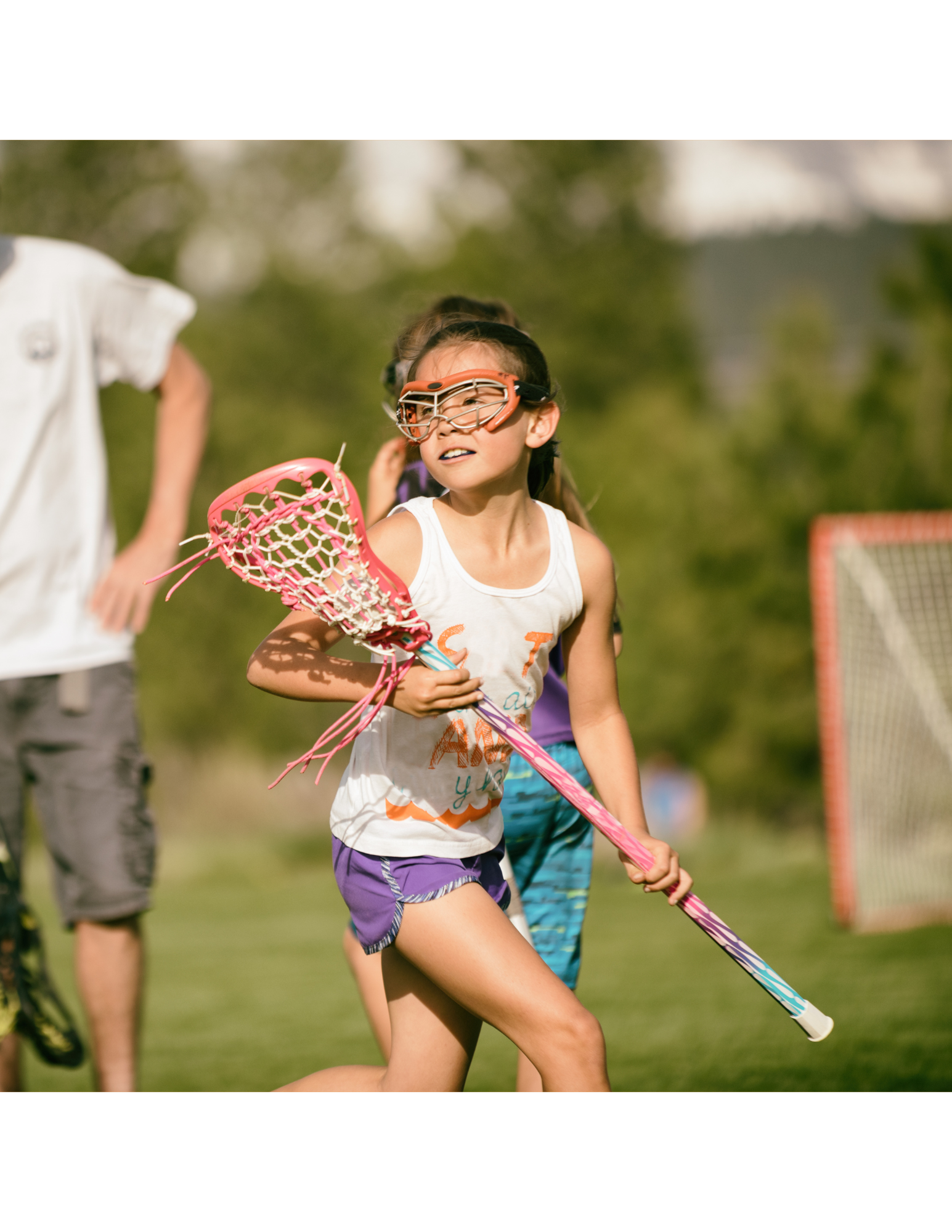 a child holding a lacrosse stick