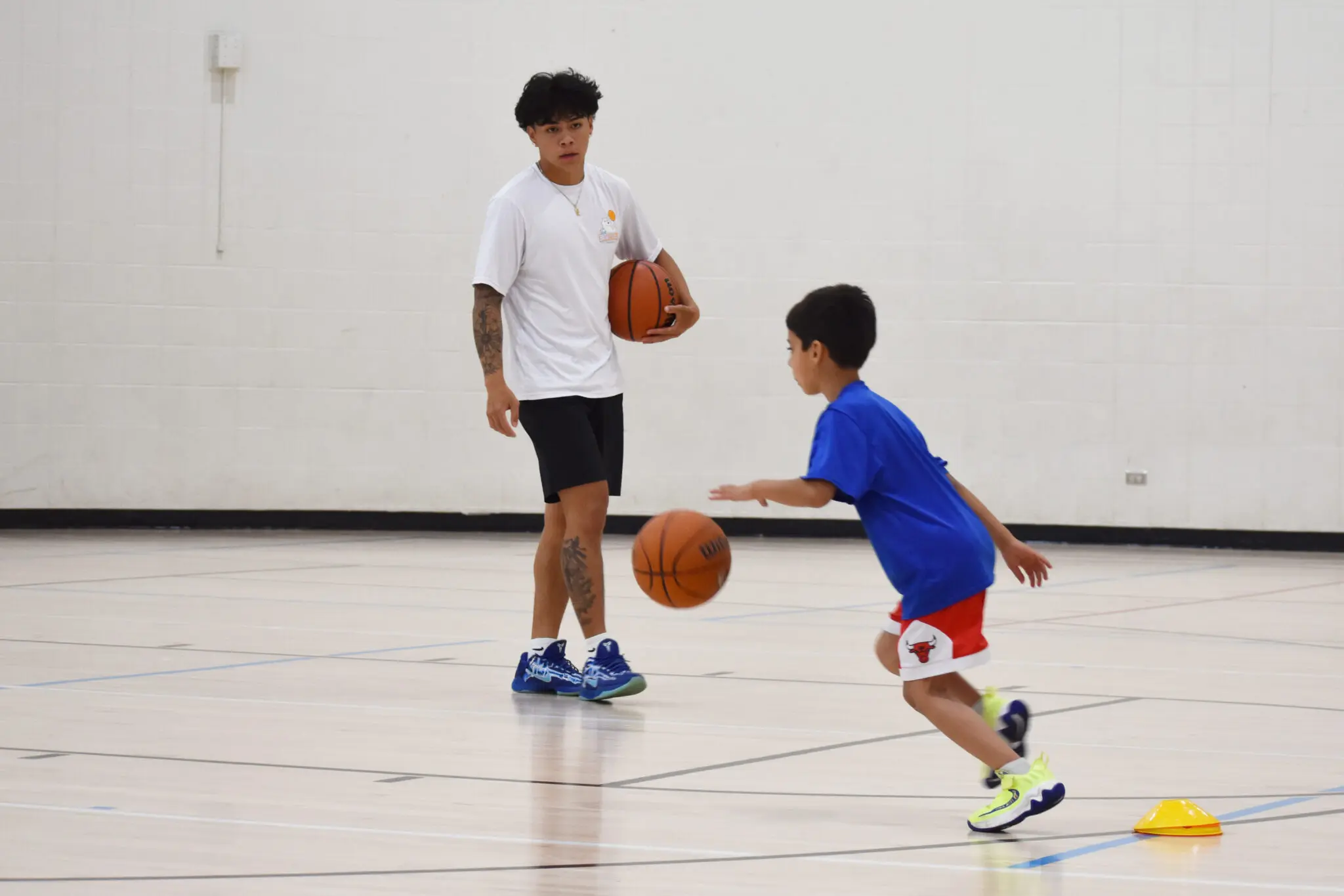 a person and child playing basketball