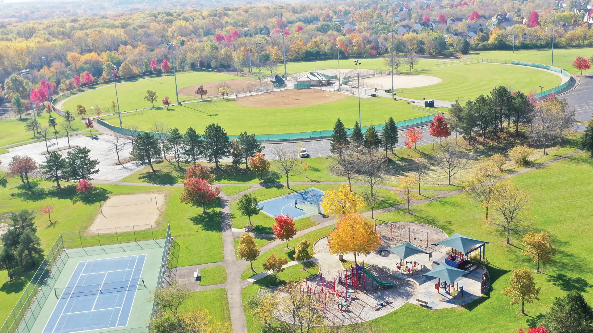 aerial view of a park with trees and a playground