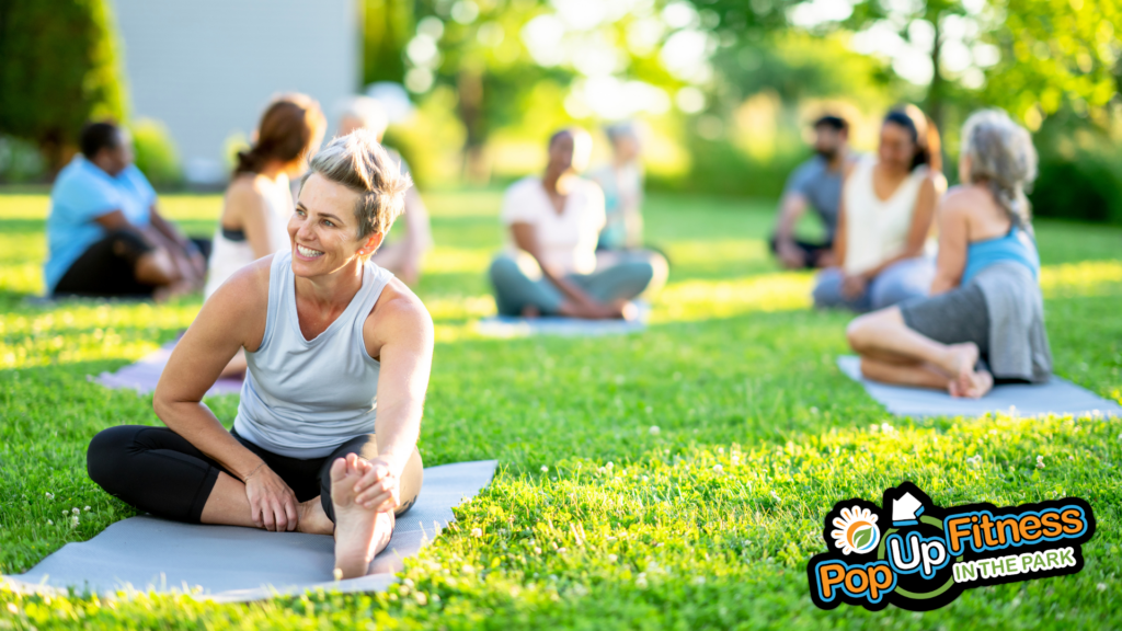 A group of people taking a Yoga class in the park