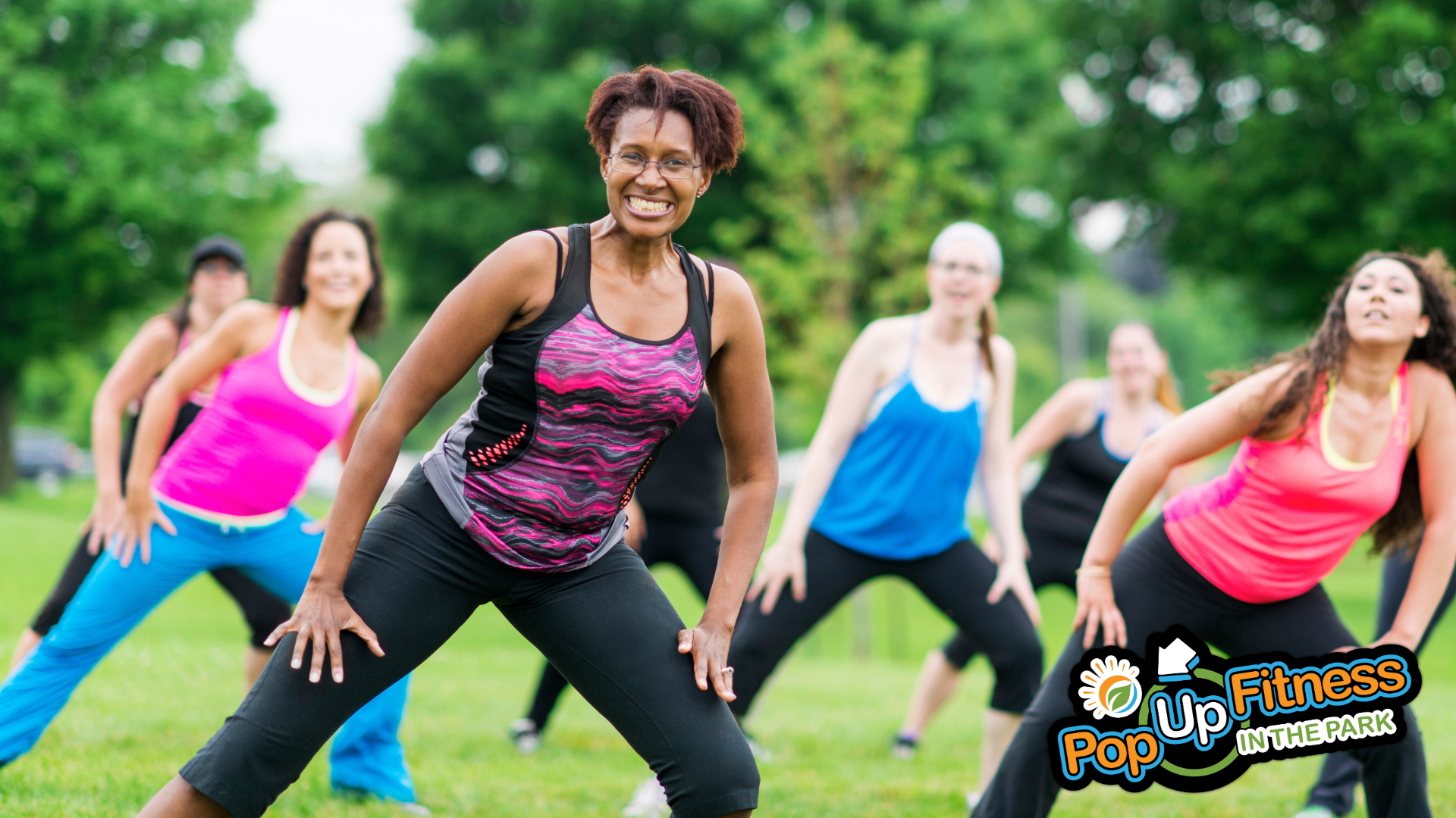 A group of people taking a Zumba class in the park