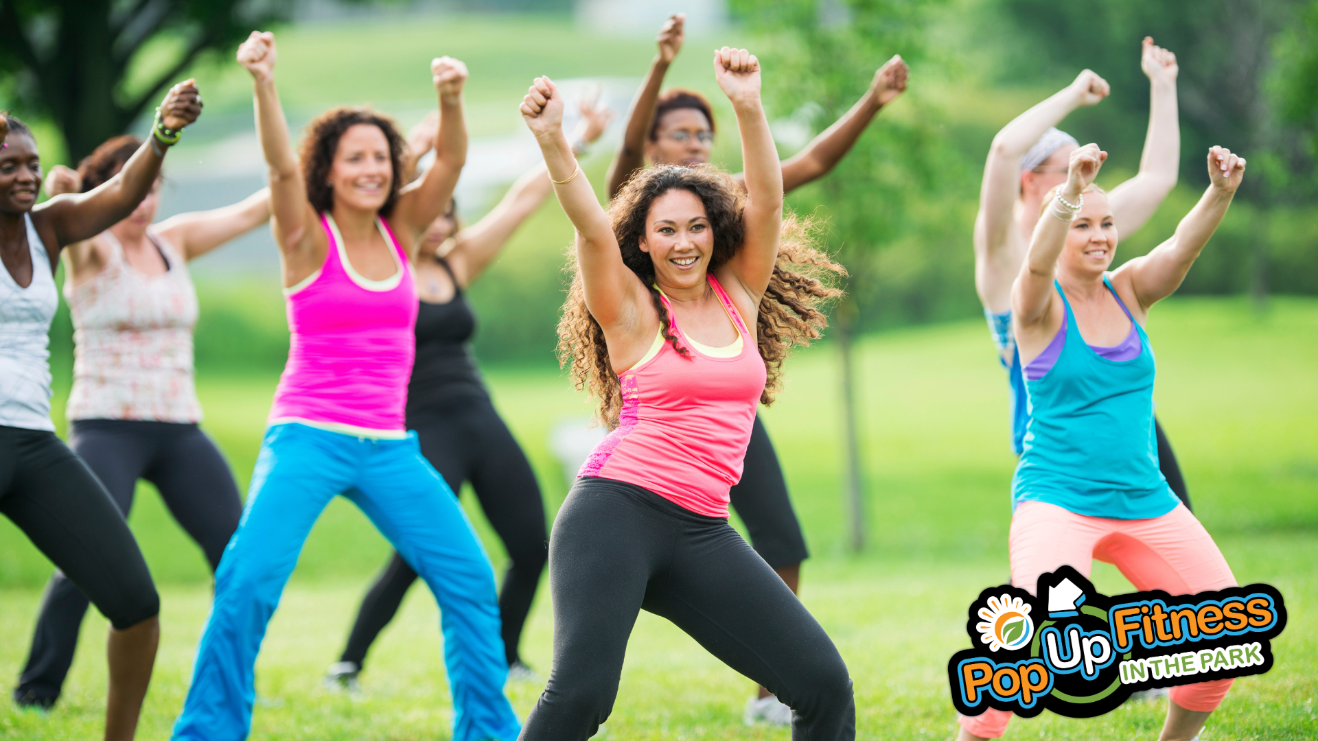 A group of people taking a Zumba class in the park