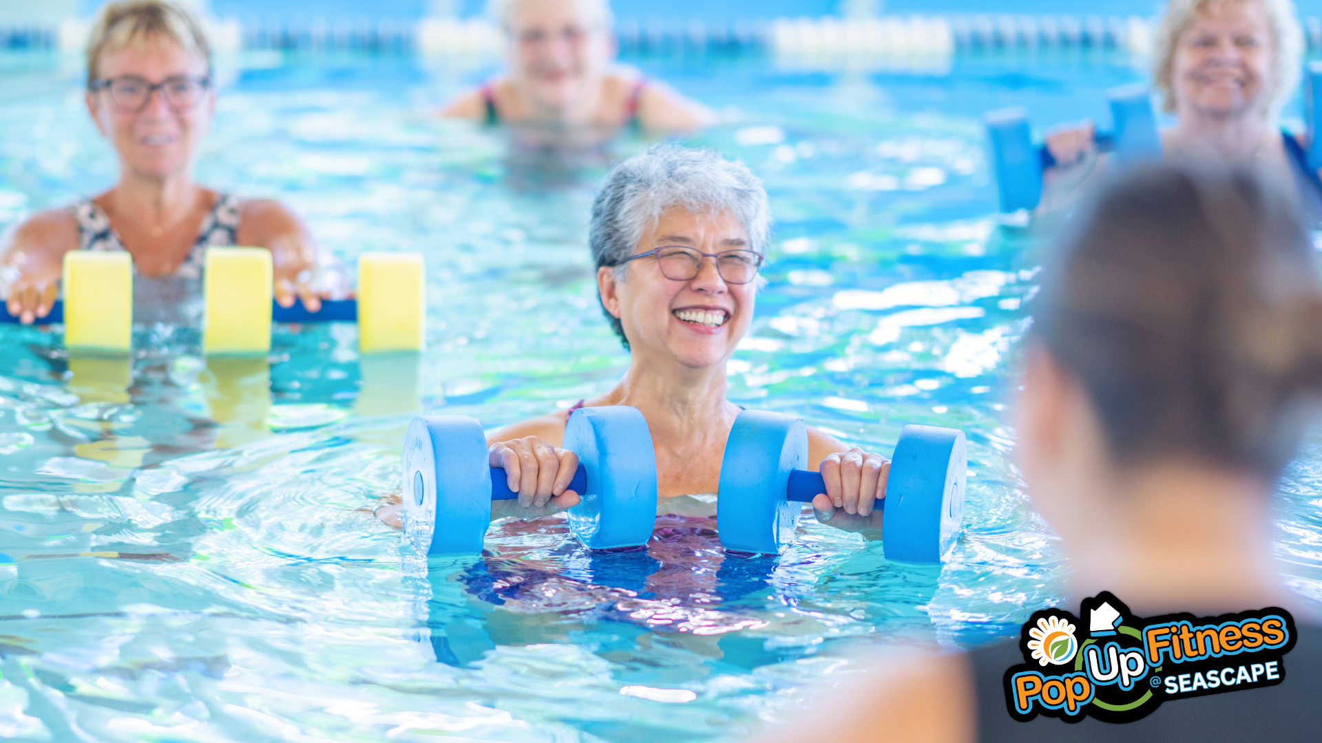 a group of people in a pool with water aerobics