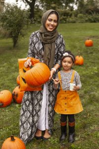 woman and girl in pumpkin patch